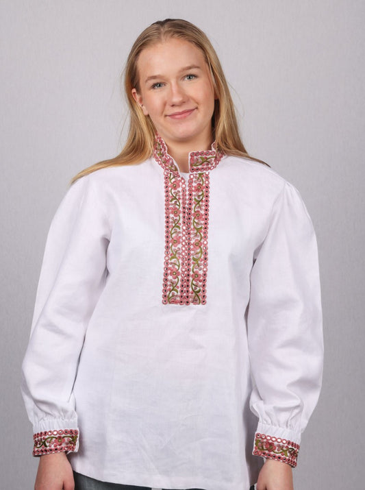 Kritthvit bomullsskjorte med nydelige detaljer på hals og ermene, med brodert bånd i nydelige farger. Skjorten kan brukes til forskjellige festdrakt og bunad.