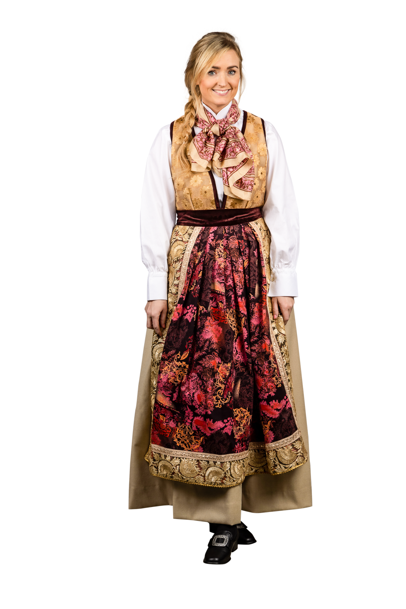 Festdrakten er inspirert av vakre høstfarger. Stakken er i lys beige ullstoff, som er lett men varm, kantet med fløyel. Livet er i silke. Håndbrodert skjorte i rød silke.
